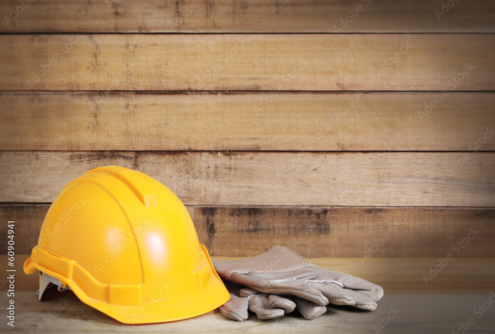 Wall mural Yellow hardhat and leather gloves