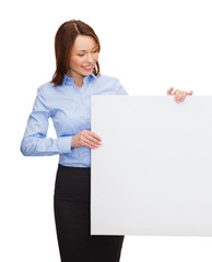 smiling businesswoman with white blank board