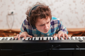 boy plays piano