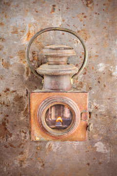 Vintage rusty lantern on a rusted steel background