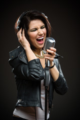 Half-length portrait of female rock singer with microphone