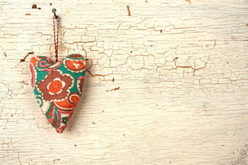 Valentines handmade heart on a  white old wooden door