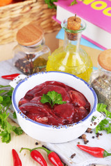 Raw liver in pan with spices and condiments