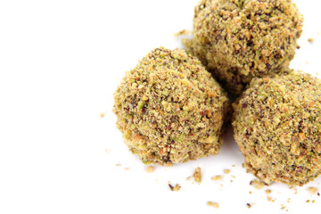 Chocolate candies with chopped pistachios, isolated on white