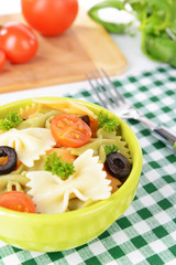 Delicious pasta with tomatoes on plate on table close-up
