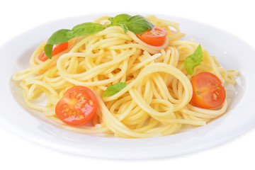 Delicious spaghetti with tomatoes on plate close-up