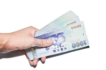 A hand holding a 1000 New Taiwan Dollar bill.