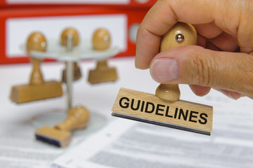 guidelines marked on rubber stamp in hand