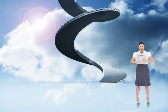 Composite image of shocked stylish businesswoman holding newspap