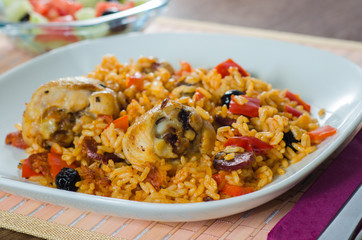Oven chicken with rice, vegetables and black olives