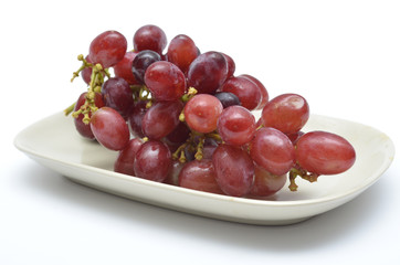 Red grape in plate on white background