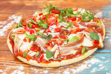 Pizza. Pizza and fresh ingredients on the table