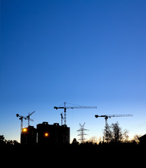 Construction site with cranes, building