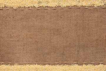 Millet  lying on sackcloth - 60920934