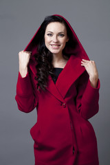 Beautiful young woman in red coat