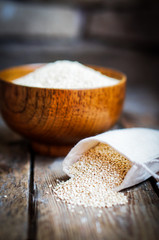 Fototapeta na wymiar White quinoa on rustic wooden background