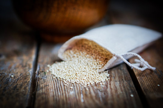 White quinoa on rustic wooden background