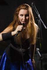 Rock star girl singing in a studio