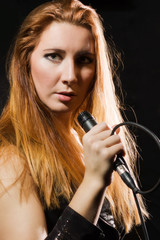 Rock star girl singing in a studio