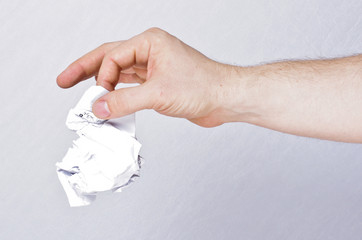 Male hand holding crumpled paper
