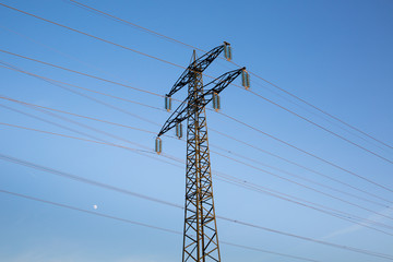 Electric power lines against blue sky