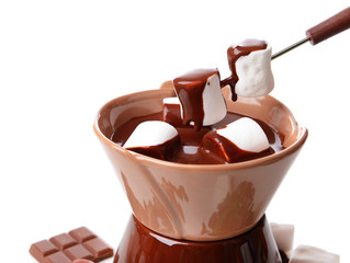 Chocolate fondue with marshmallow candies, isolated on white