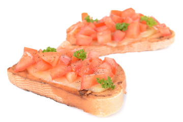 Delicious bruschetta with tomatoes isolated on white