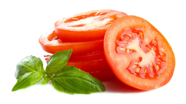Slices of fresh tomato with basil, isolated on white