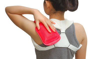 woman putting a hot pack on her shoulder pain