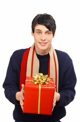 Man with sweater and scarf giving you a big Christmas gift.