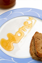 Honey word written on plate isolated on white