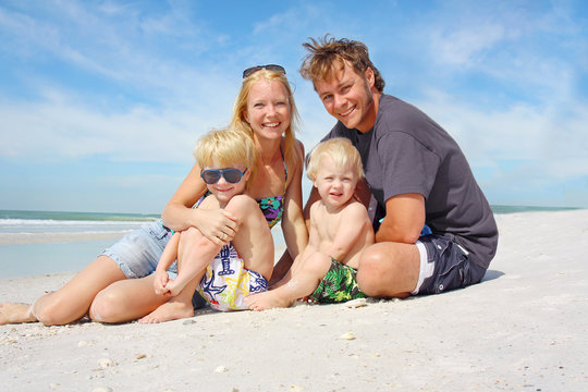 Happy Family of Four at Beach
