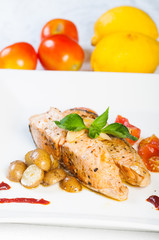 salmon belly garnish with pesto potatoes and friend tomatoes