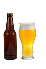 Unopened bottle of beer along with a full glass of beer