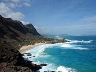 Fototapeta premium Waves crash on Makapuu Beach with the Koolau Range Mountains abo