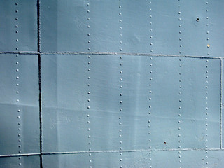 Detailed gray metal historic ship wall with seams and rivets. wi