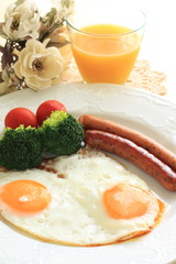 sunny side up egg and pan fried sausage for breakfast image