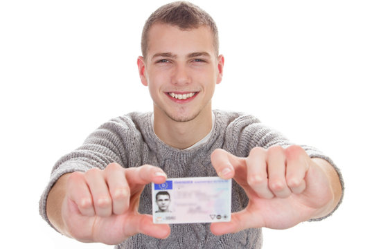 Young man showing his driver license