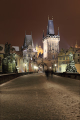 Obraz premium Night snowy Prague Charles Bridge and St. Nicholas' Cathedral