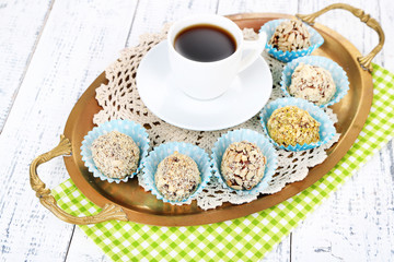 Set of chocolate candies, on tray, on color wooden background