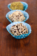 Set of chocolate candies, on wooden background