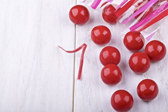 Red candies on a painted white background