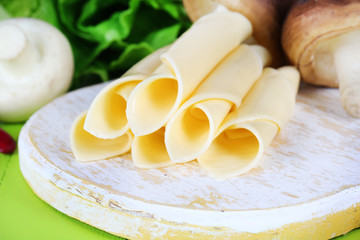 Cream cheese with vegetables and greens on wooden table