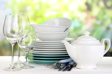 Clean dishes on table on natural background