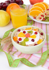Delicious oatmeal with fruit in bowl on table close-up