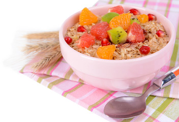 Delicious oatmeal with fruit in bowl on table close-up