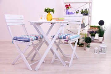 Garden chairs and table with flowers