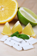 Chewing gums with fruit taste,   on color wooden background