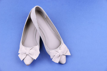 Beautiful grey female shoes, on blue background