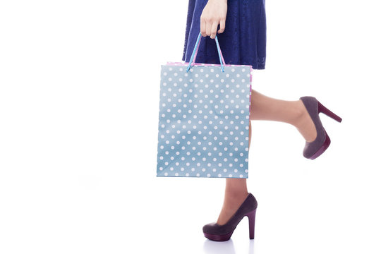Woman holding shopping bags, isolated on white